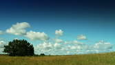 Time lapse clip - Summer clouds move through natural landscape – pan