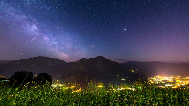 Milky Way above lit valley - Dolly Shot